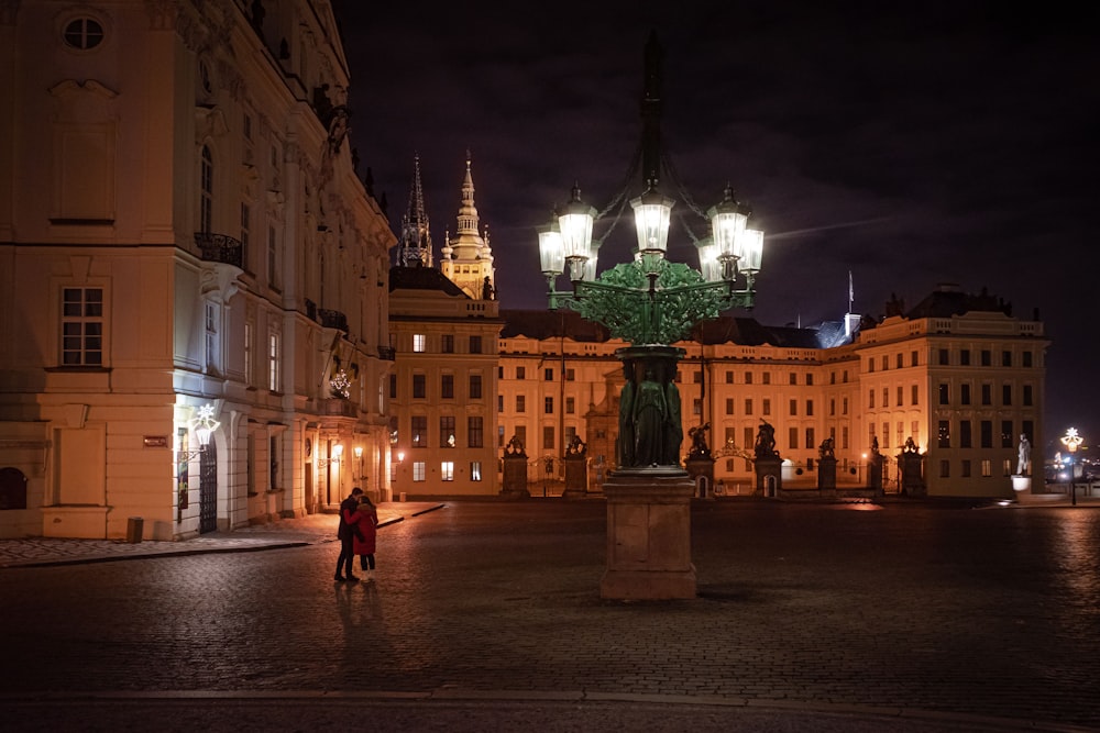 a person standing in front of a building at night