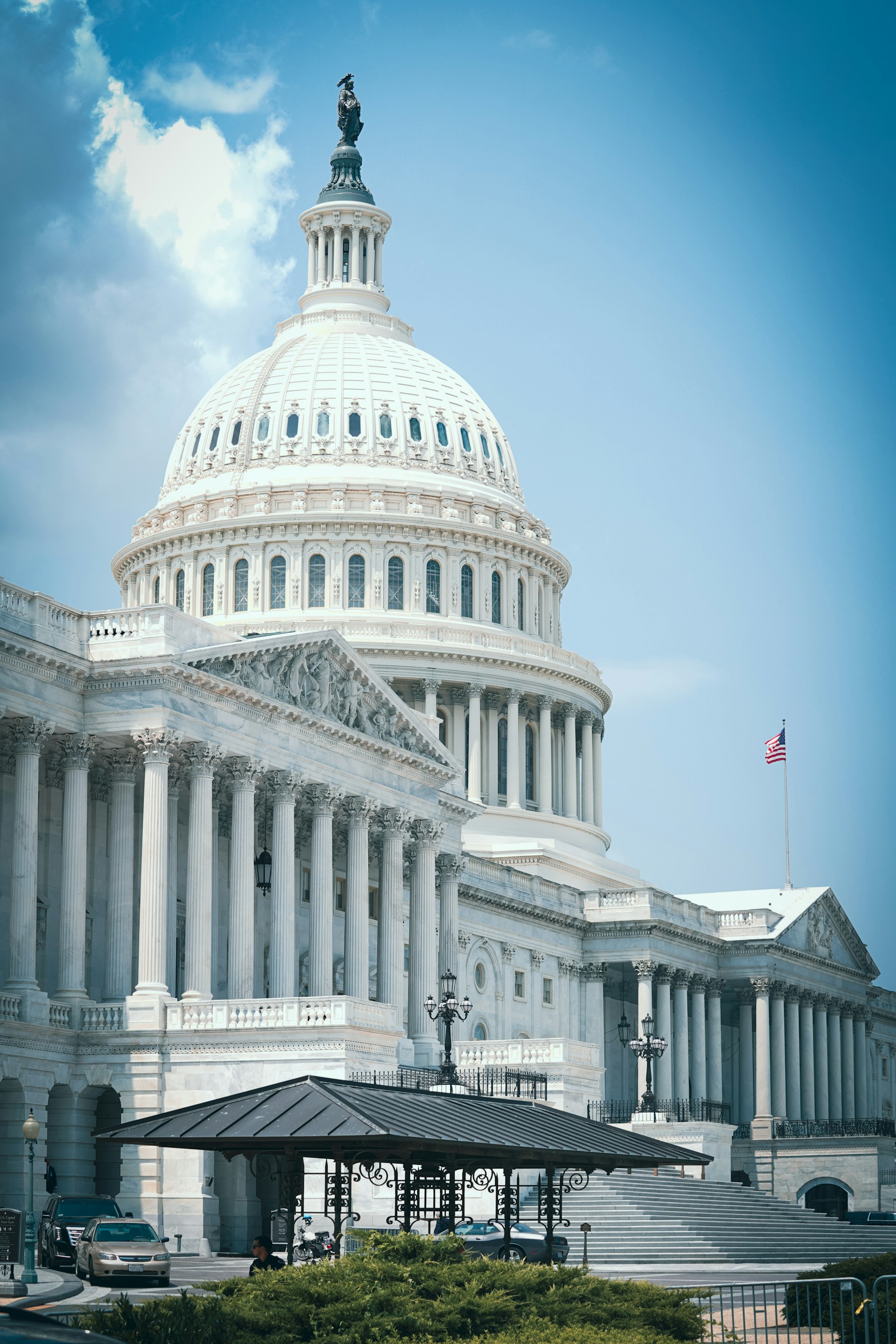 a large white building with a flag on top of it