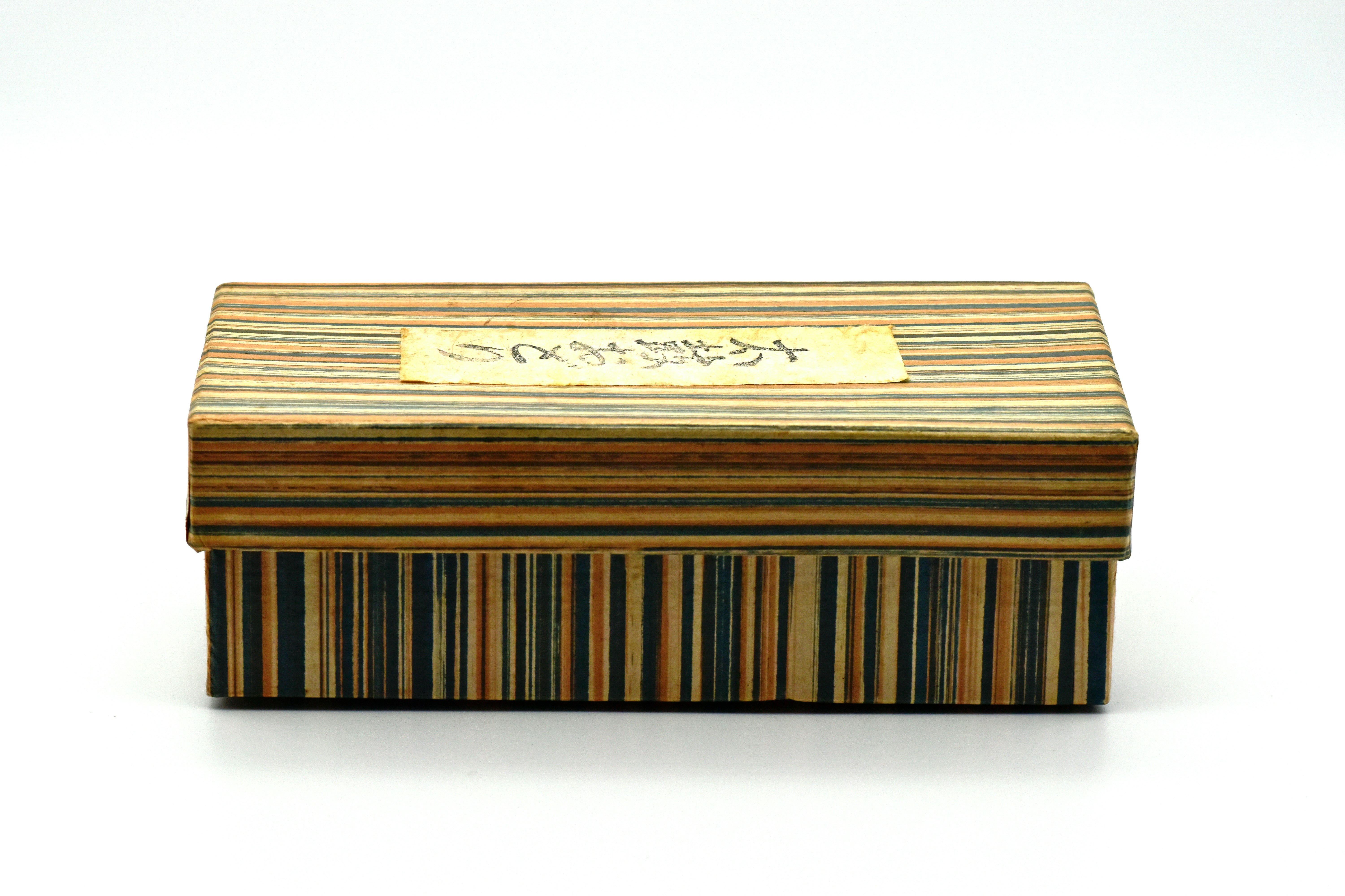 Striped box with writing on the lid