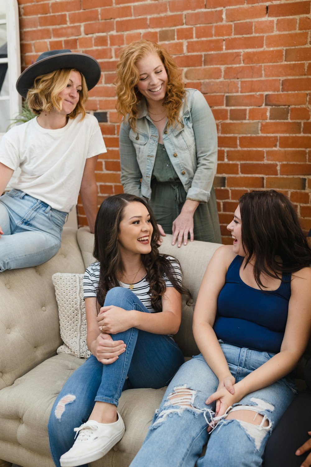 a group of women sitting on top of a couch