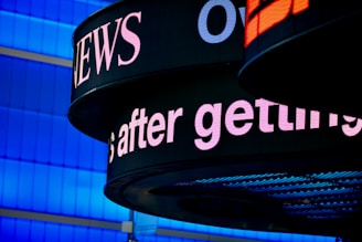 a close up of a sign with a building in the background