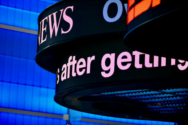 a close up of a sign with a building in the background