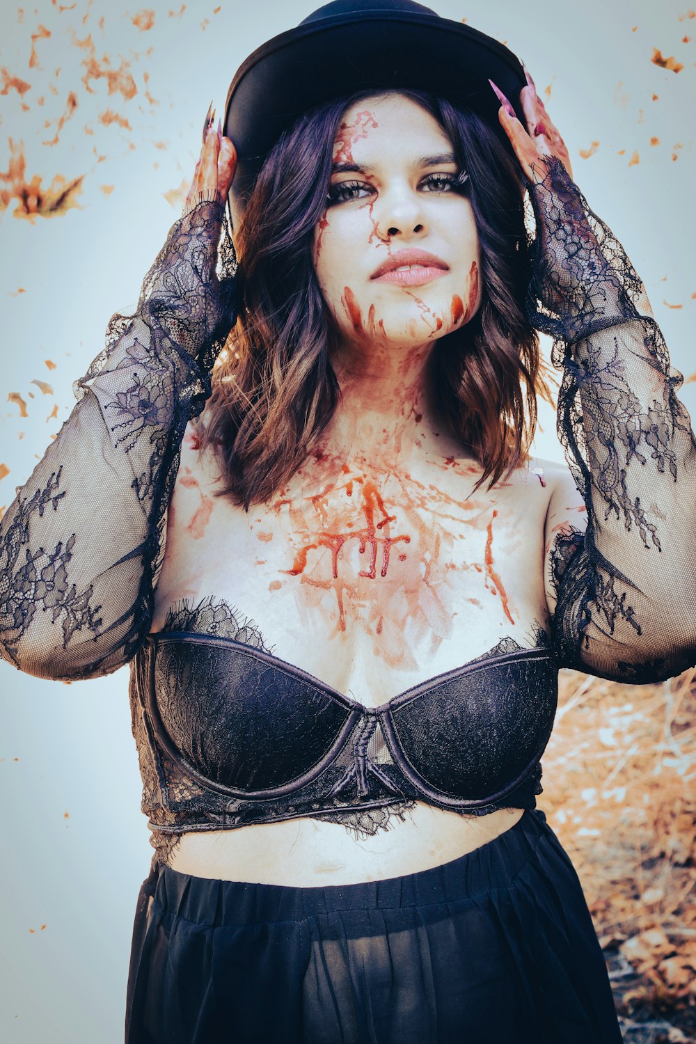 a woman in a bra top with blood all over her face