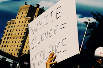 a protest sign being held up by people