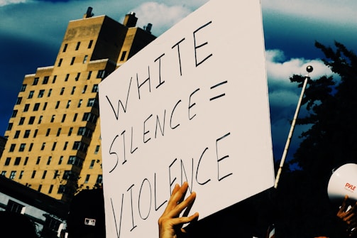 a protest sign being held up by people