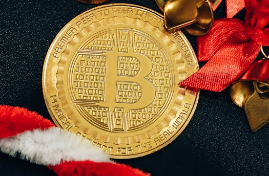 a golden bitcoin sitting on top of a black table