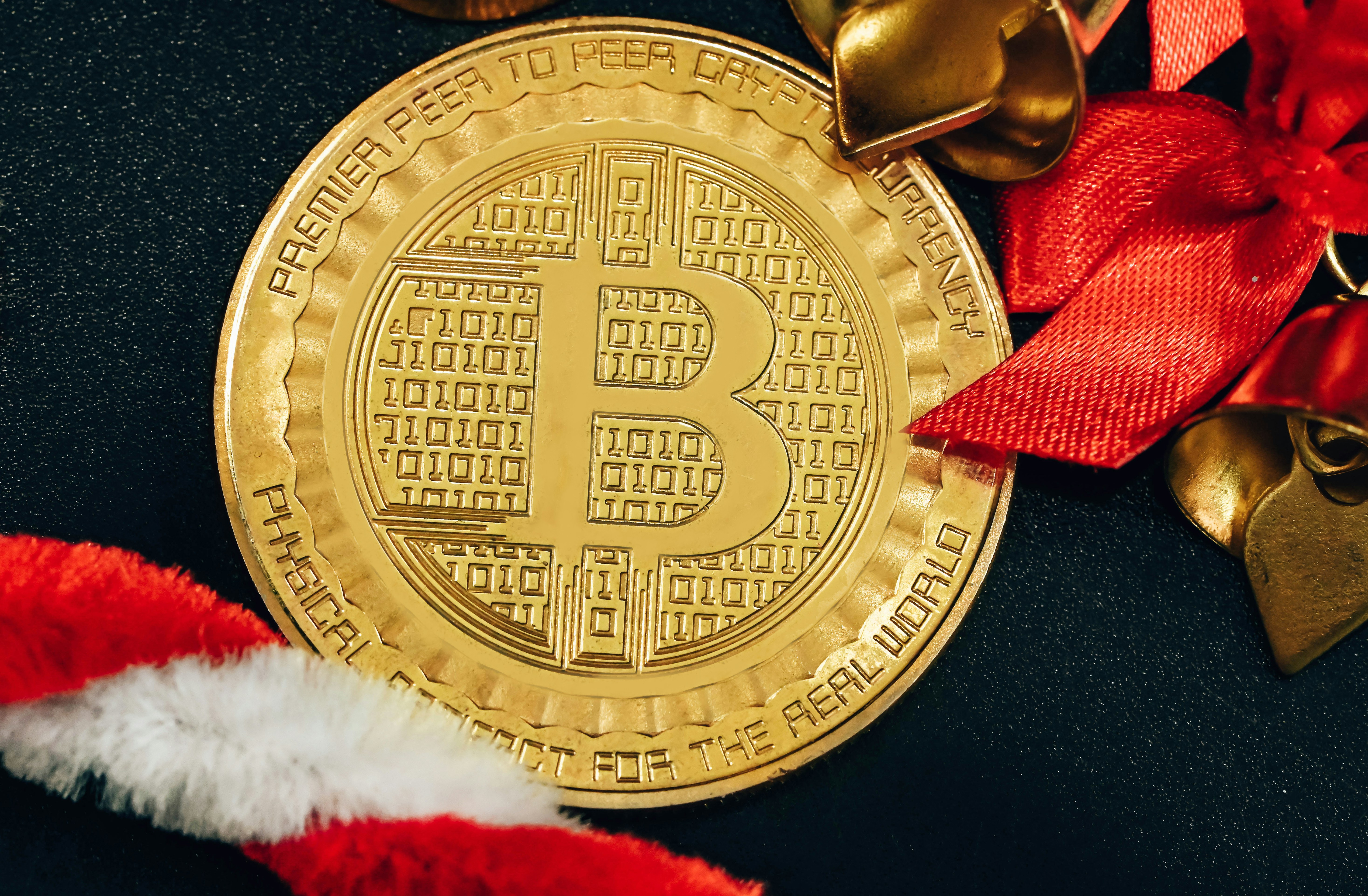 A single Bitcoin in the middle of candy cane and jingle bell