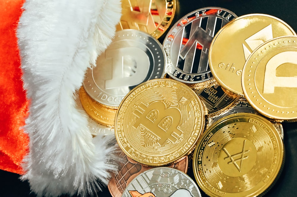 a pile of bitcoins with a santa hat on top of it