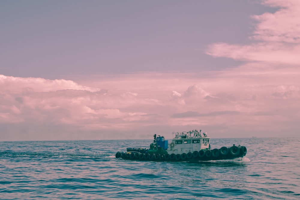 a small boat floating on top of a large body of water