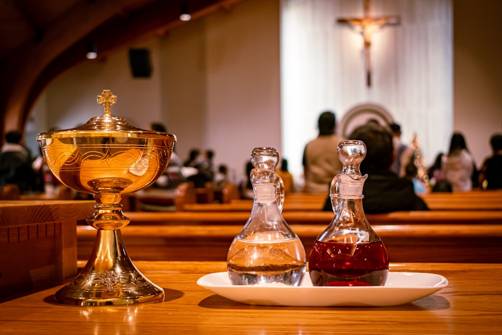 a wooden table topped with two bottles of liquor