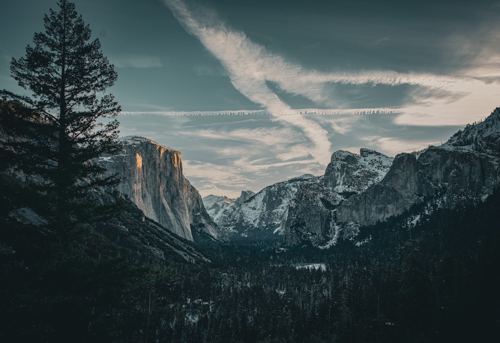 a view of a mountain range with clouds in the sky