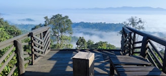 A sturdy wooden deck built on a hillside home overlooking the valley