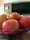 Photo of a cheerful young male nutritionist holding a bowl of fresh fruits in a cozy kitchen setting.