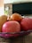 Photo of a cheerful young male nutritionist holding a bowl of fresh fruits in a cozy kitchen setting.