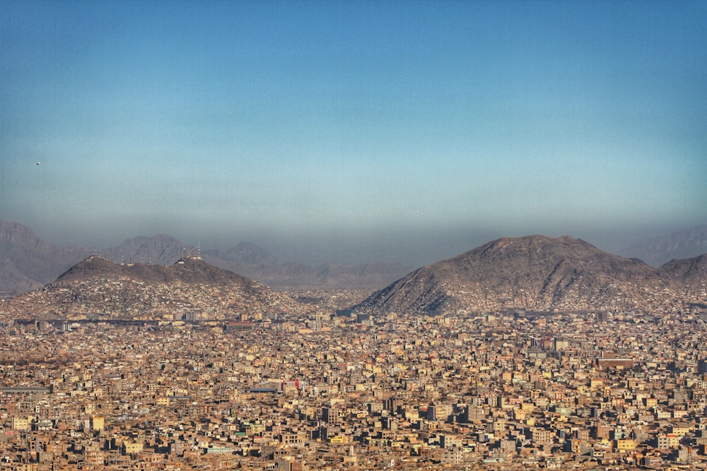 a view of a city with mountains in the background