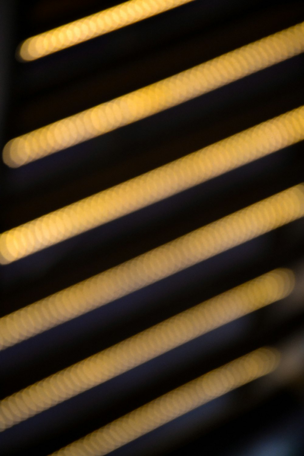 a close up of a metal grill with yellow lights