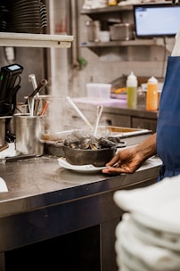a person standing in a kitchen preparing food