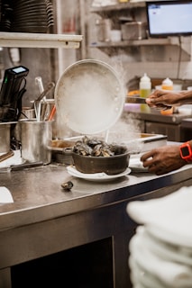 Close-up of a chef preparing fresh seafood in a kitchen.