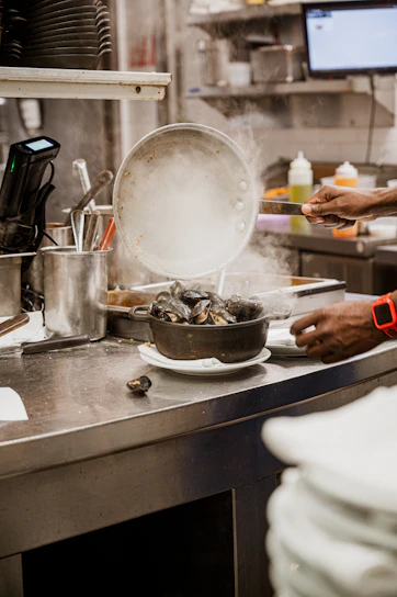 Urban kitchen scene with a young person preparing shrimp and vegetable instant soup.