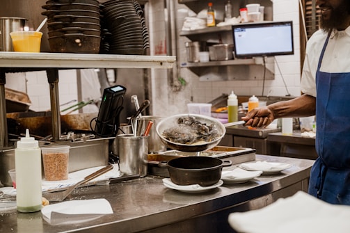 a man standing in a kitchen preparing food