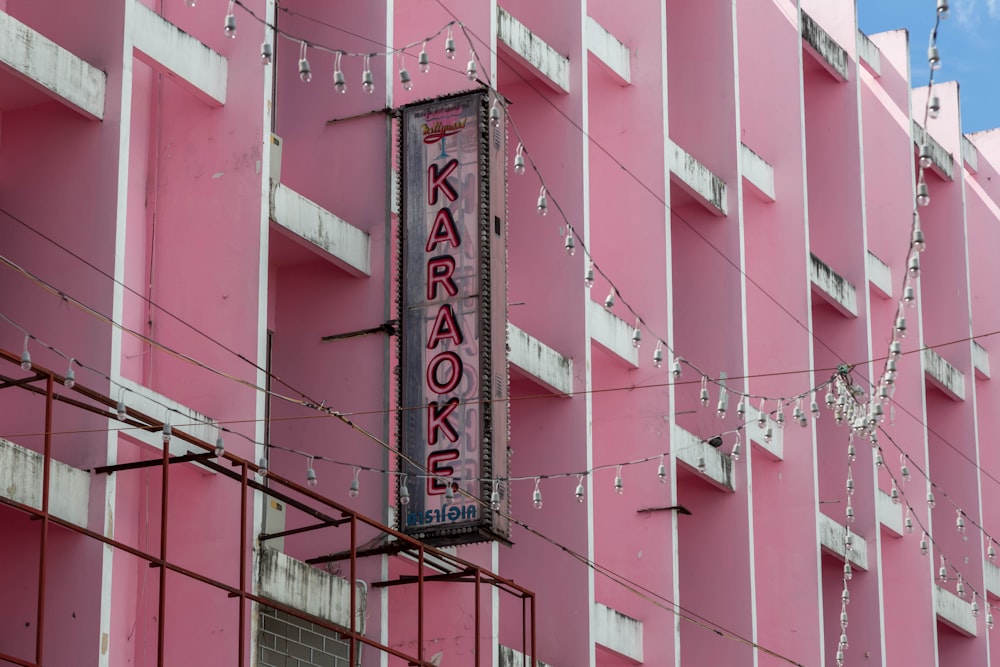 a pink building with a sign on the side of it