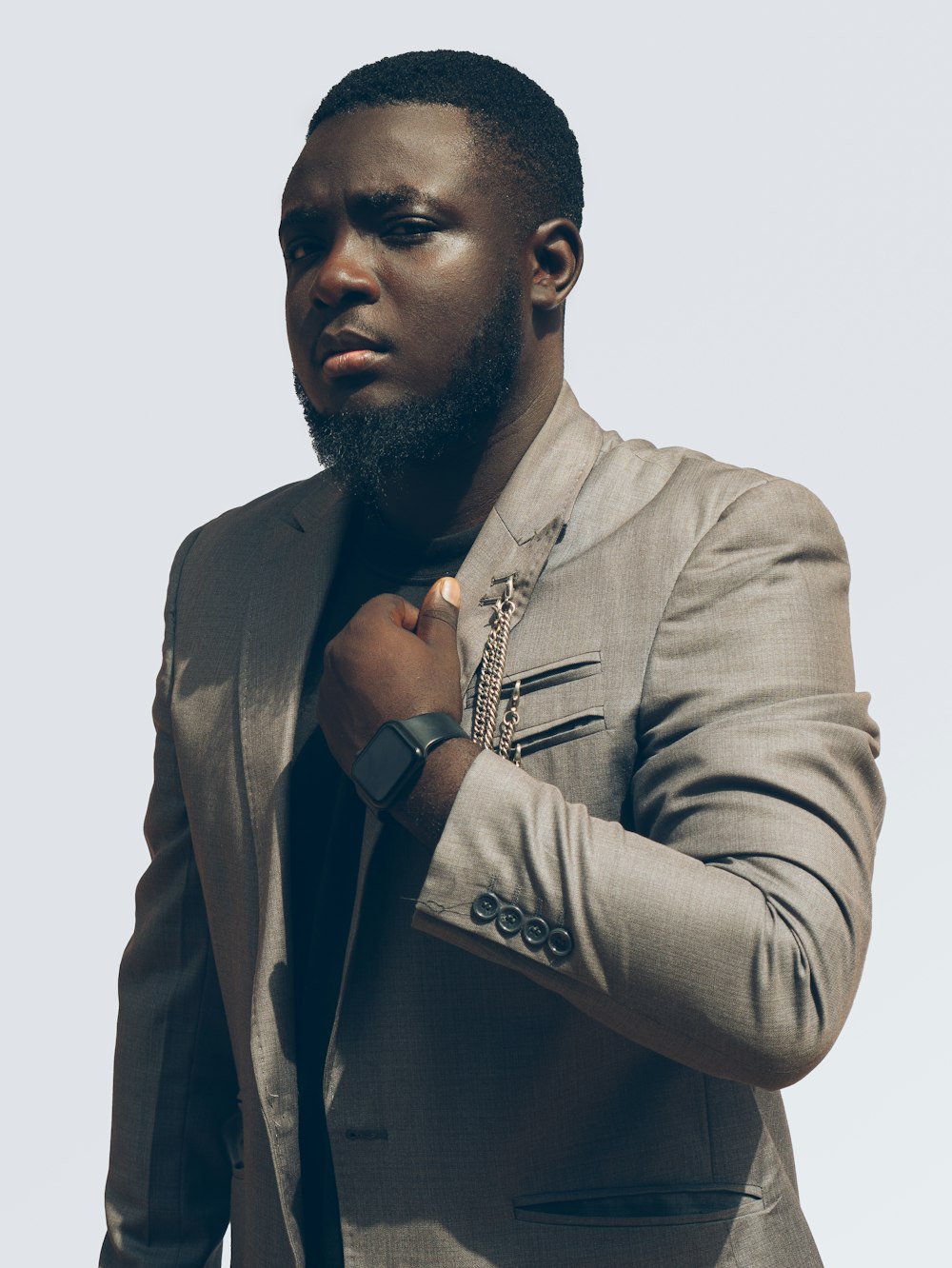 a man in a suit adjusting his tie