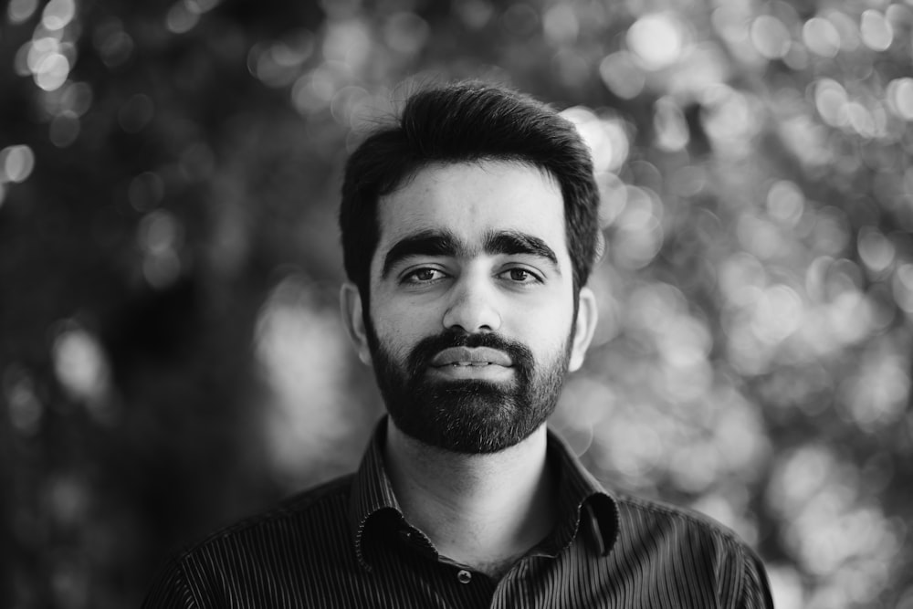 a black and white photo of a man with a beard