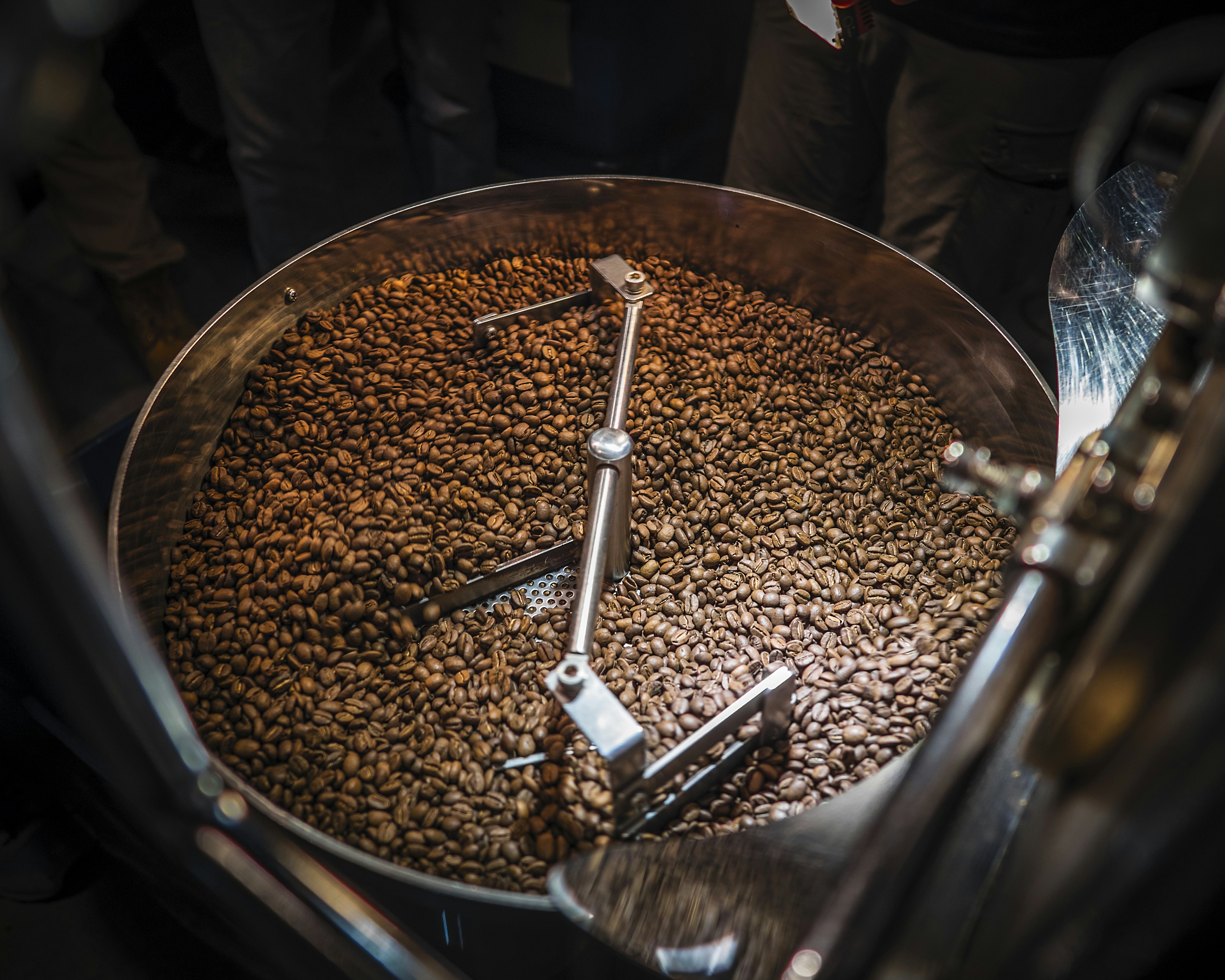 Overhead view of a roaster cooling bowl full of beans