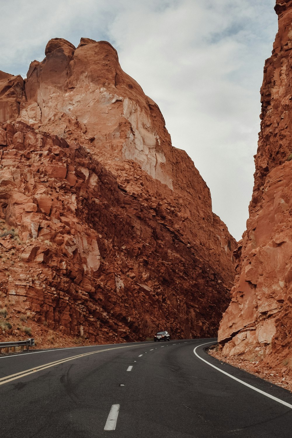 a car driving down a mountain road in the desert