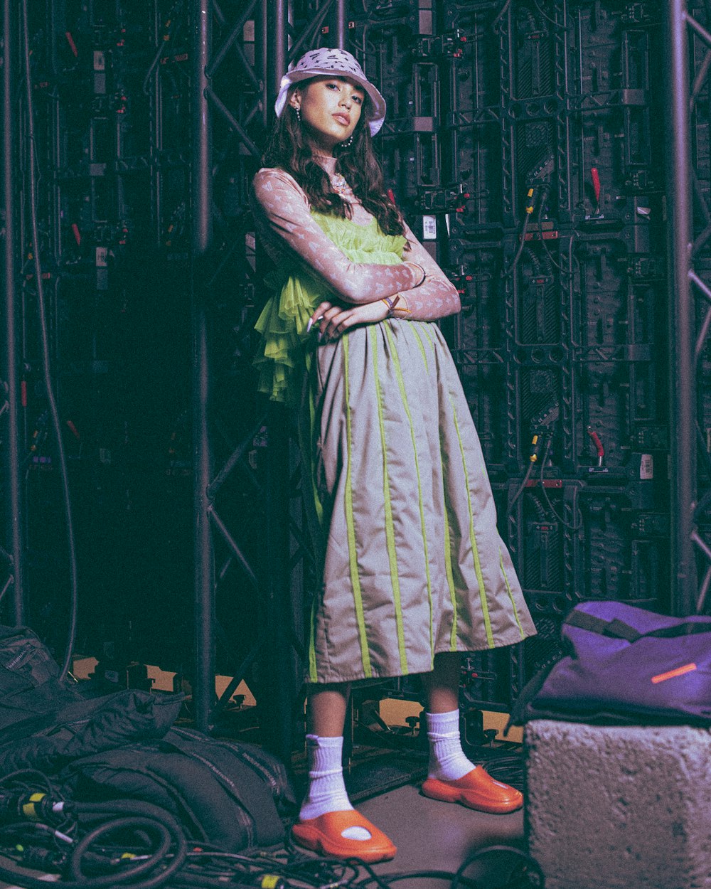 a woman standing in front of a bunch of wires