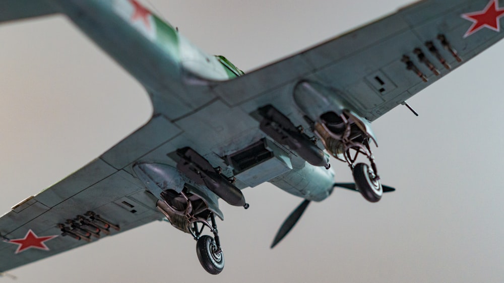 a fighter jet flying through a cloudy sky