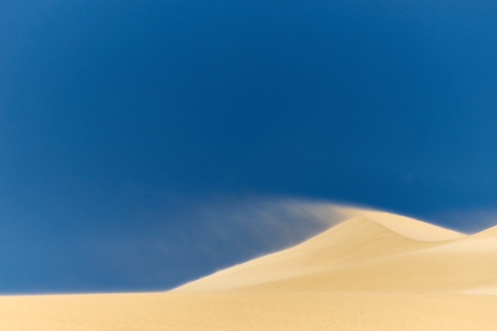 a white sand dune under a blue sky