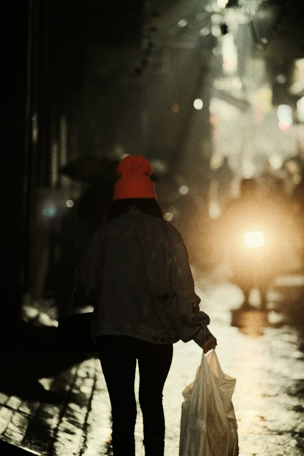 a person walking down a street holding an umbrella