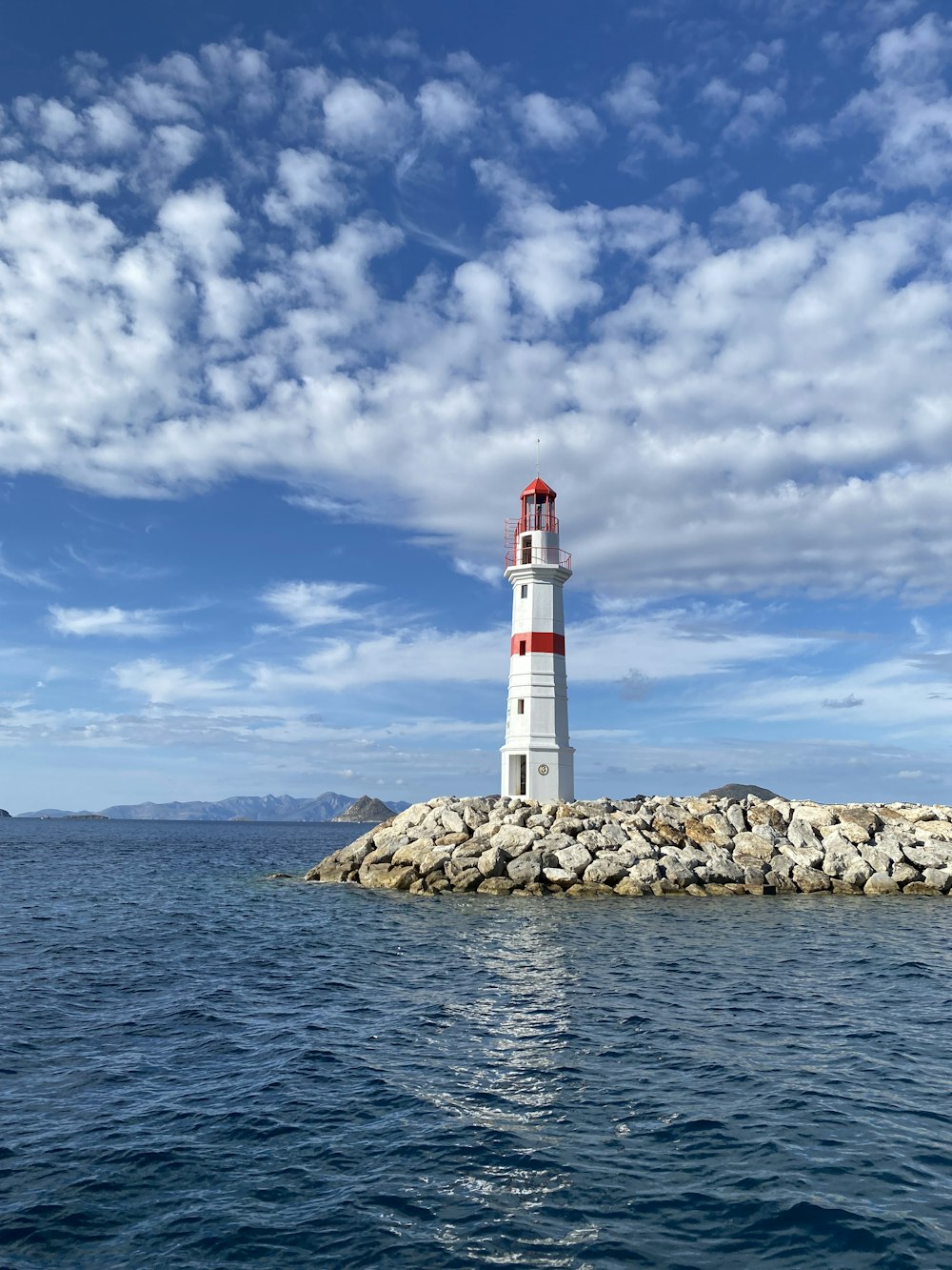 a light house sitting on top of a small island