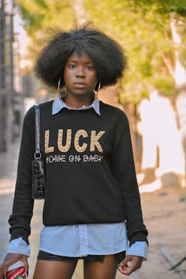 a woman with an afro is walking down the street