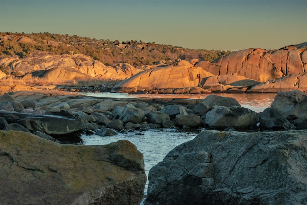 a body of water surrounded by large rocks