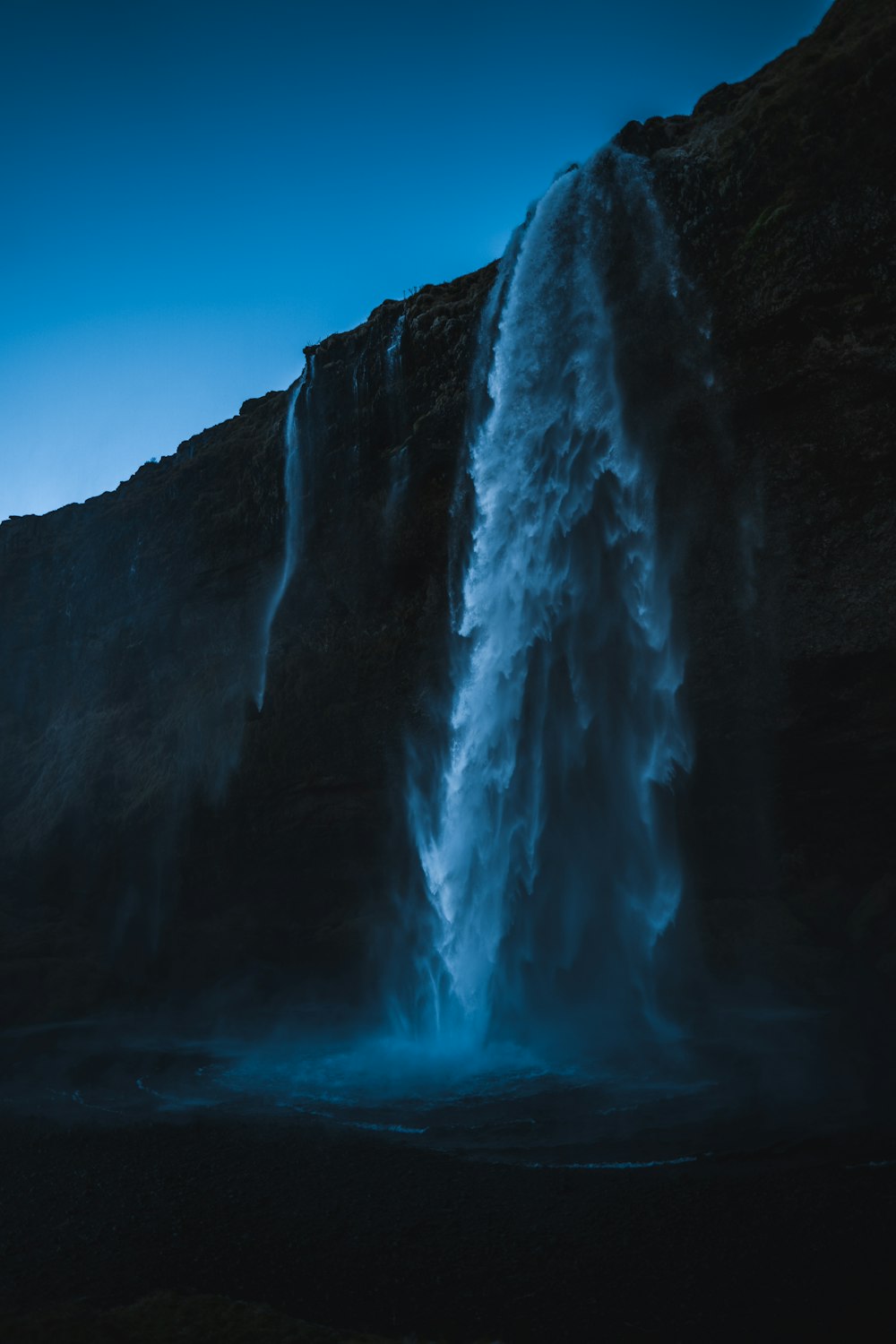 a very tall waterfall with water pouring out of it