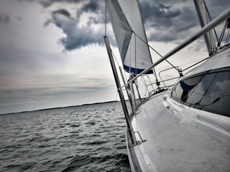 A detailed view of a sleek boat on calm waters under a clear sky.