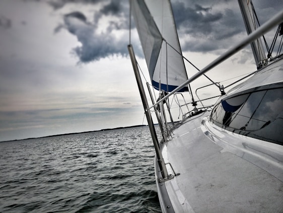 A detailed view of a sleek boat on calm waters under a clear sky.