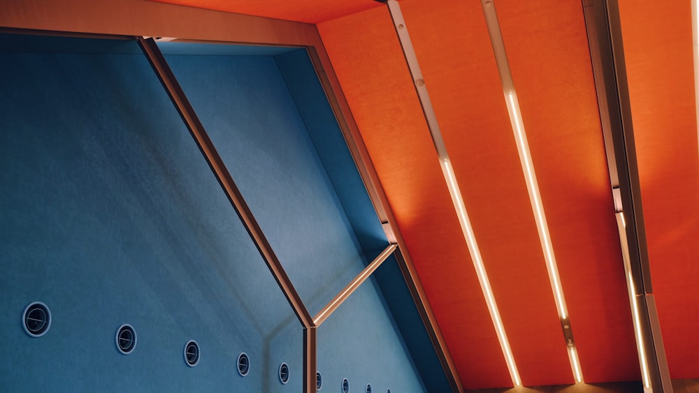 a bathroom with a blue wall and orange walls