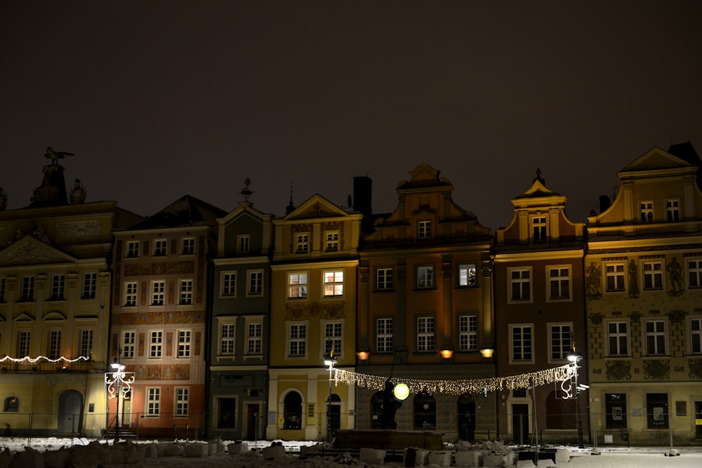 a row of buildings with lights on each of them