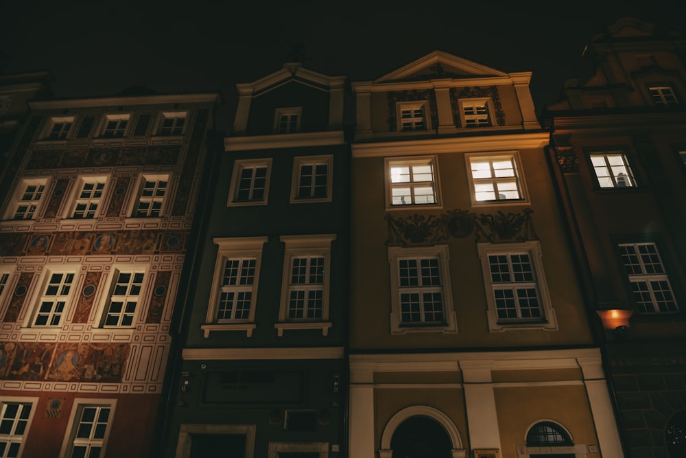 a row of buildings lit up at night