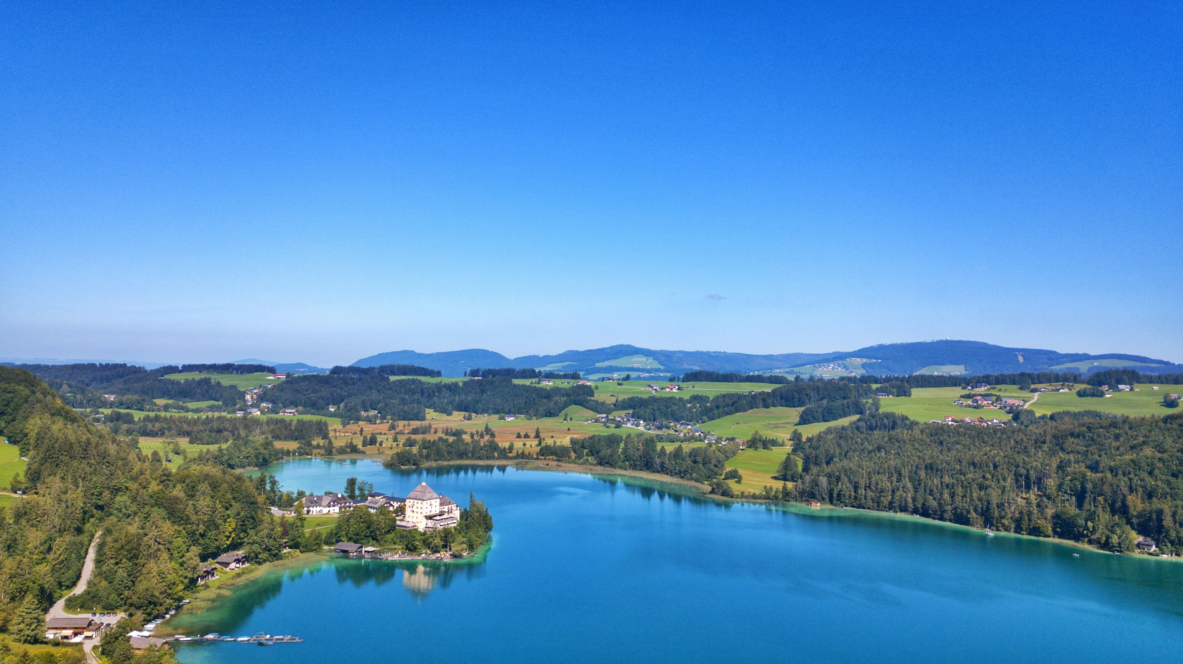 an aerial view of a lake surrounded by mountains