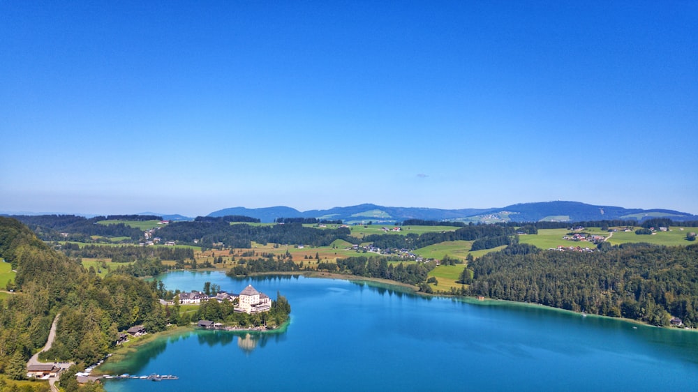 an aerial view of a lake surrounded by mountains