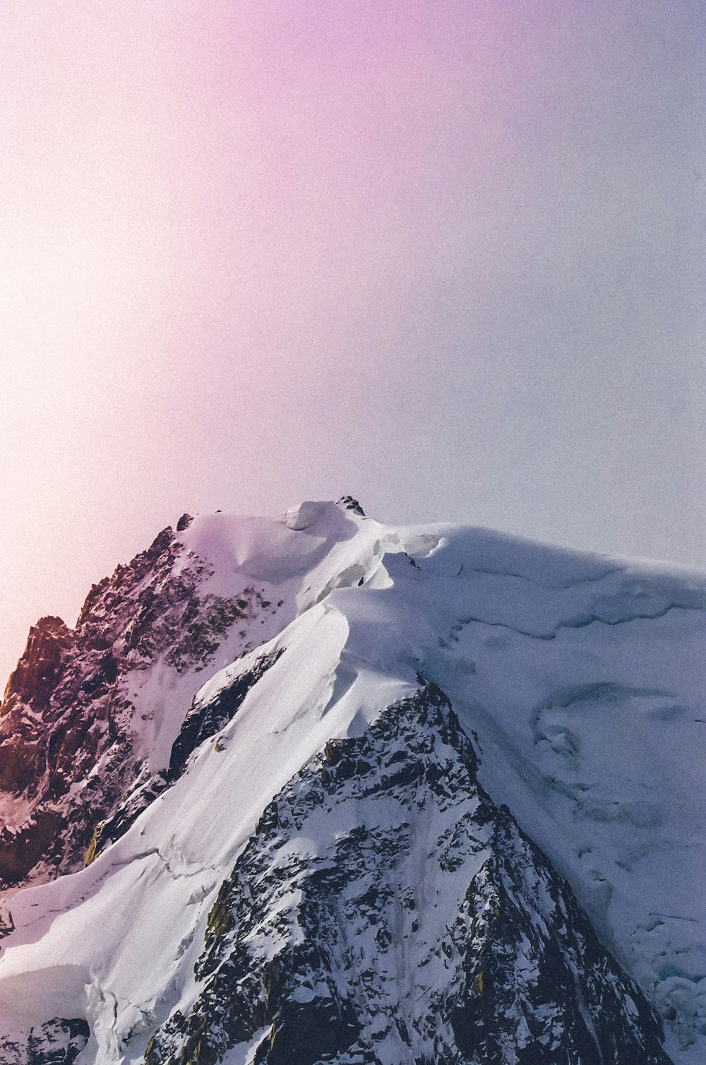 a snowboarder is standing on the top of a mountain