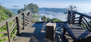 a wooden bench sitting on top of a wooden bridge