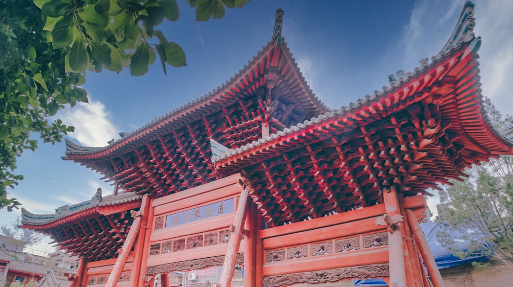 a tall red building with a sky background