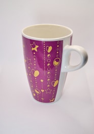 A ceramic mug featuring a bright, personalized print with a modern design.
