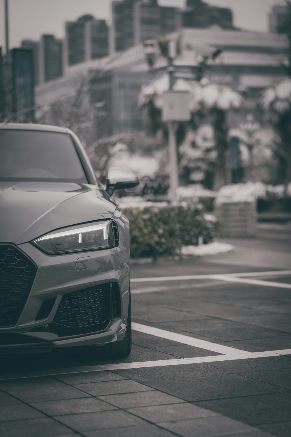 a grey car parked in a parking lot