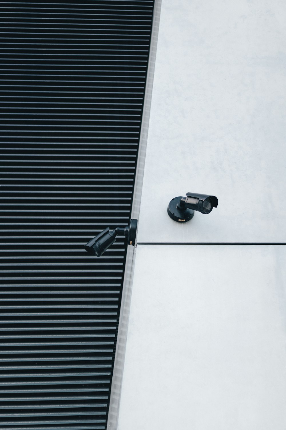 a pair of black shoes sitting on the side of a building